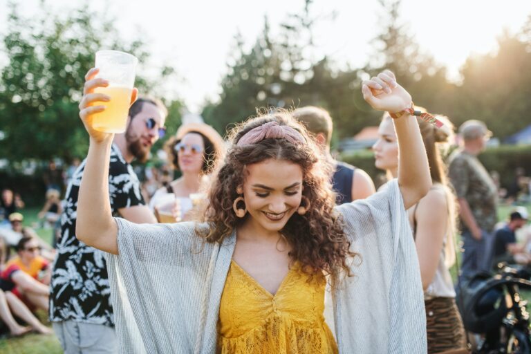 a-young-woman-with-drink-dancing-at-summer-festival